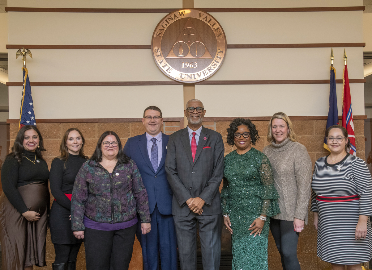 group of people surrounding SVSU President George Grant Jr